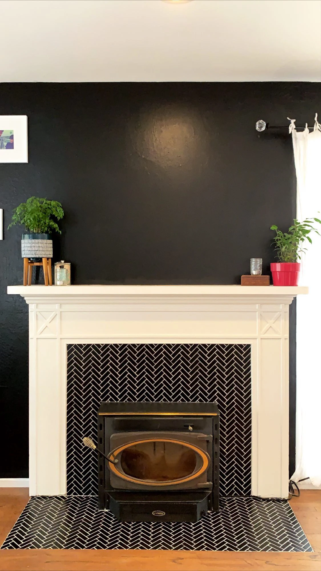 Black herringbone tile fireplace surround