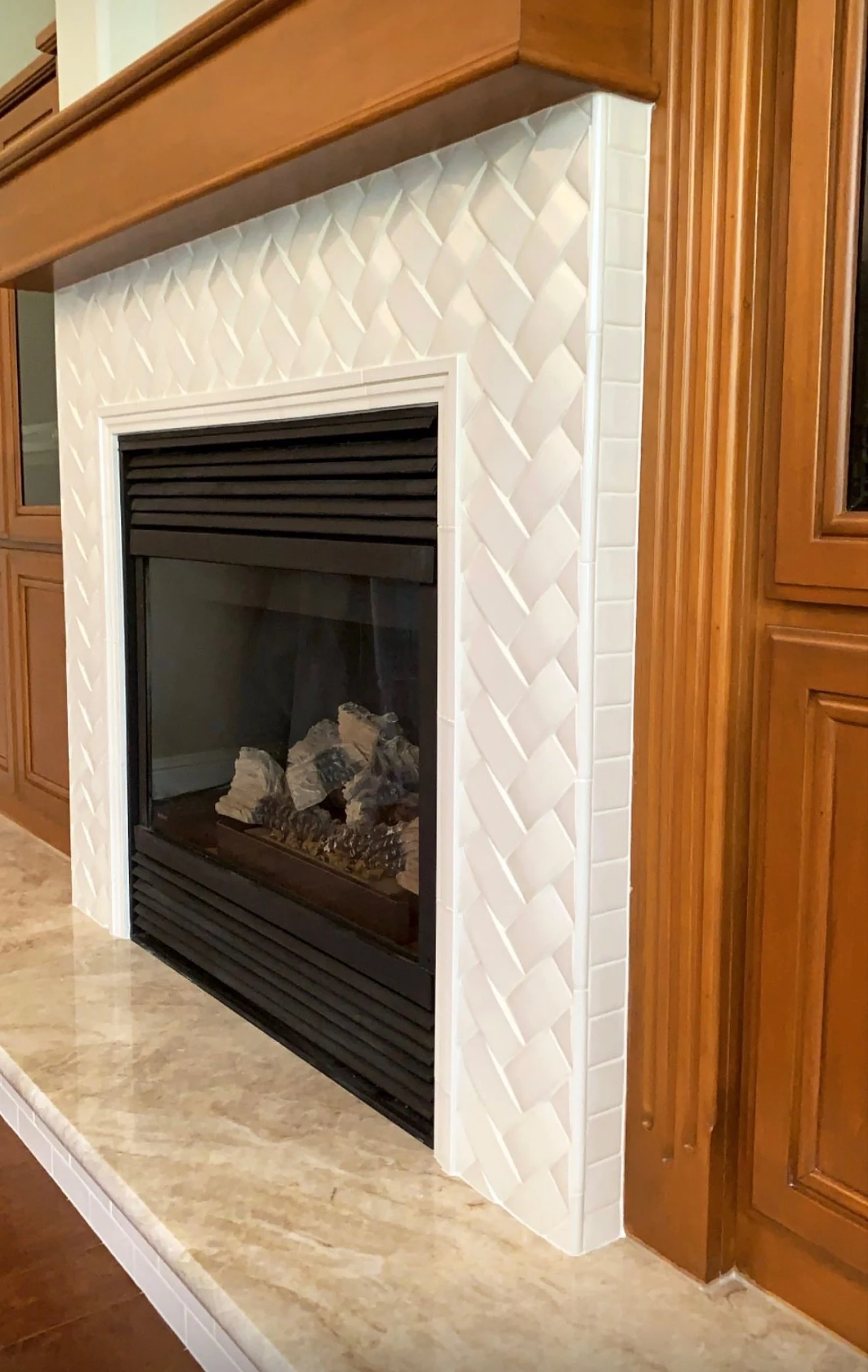 White herringbone tile fireplace surround