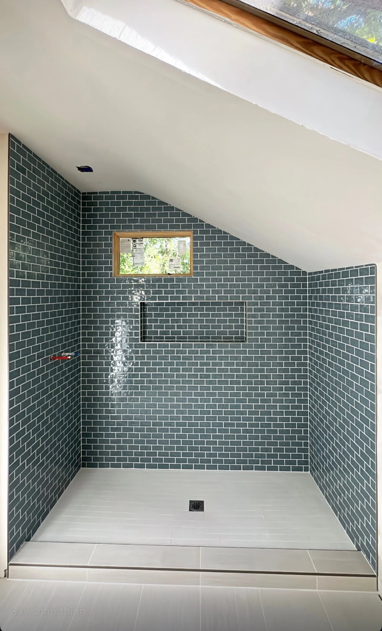 Blue subway tile walk-in shower